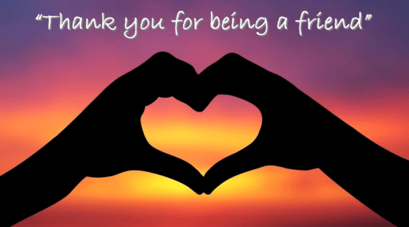 A sunset of yellow, orange, and purple. A set of shadowed hands are curved to make a heart. White text reads "Thank you for being a friend."