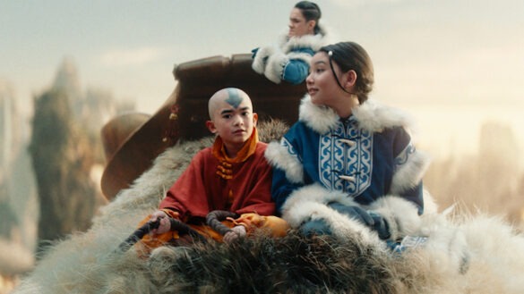 A screen capture of Avatar the Last Airbender. Aang, a young boy, is riding on a sky bison with friends Katara and Sokka.