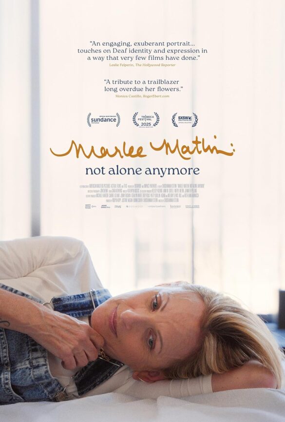 Marlee Matlin Not Alone Anymore documentary poster- Marlee, a white woman with short blonde hair, laying on a tattoo table bed